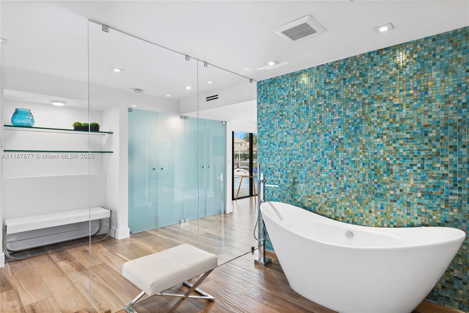 Soaking tub oasis with mosaic wall