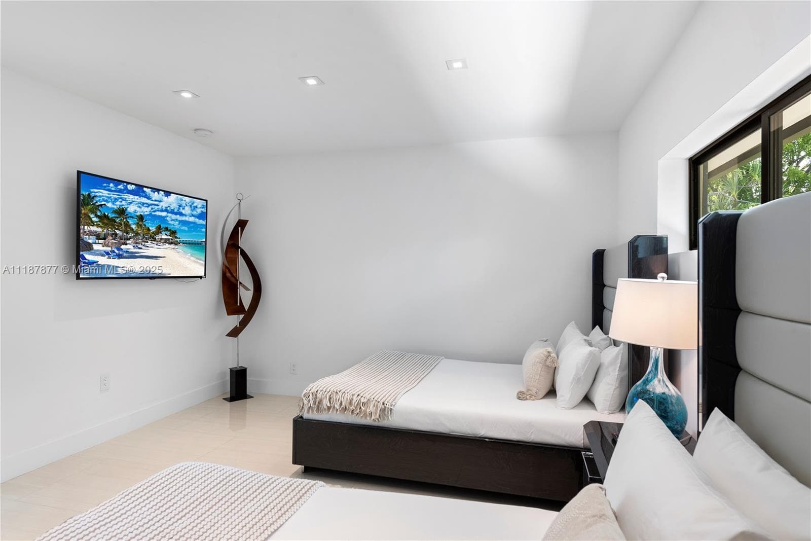 Minimal bedroom with TV and art