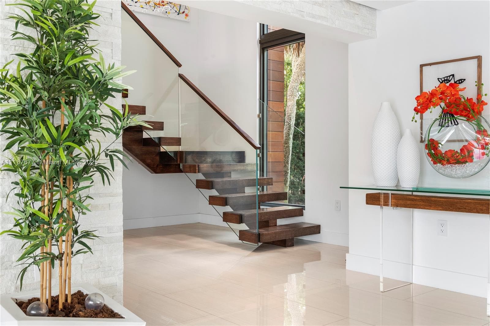 Entry hall with floating stairs and art