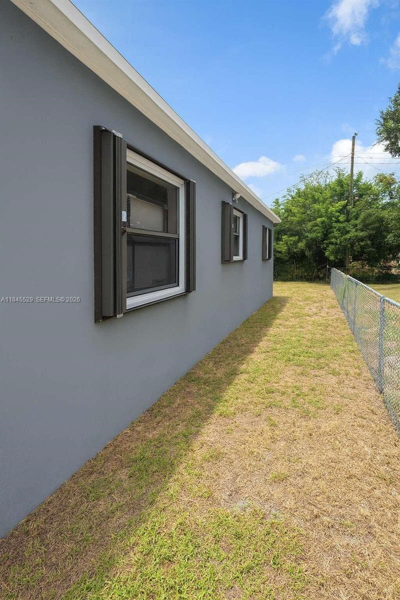 Enclosed carport with side entrance