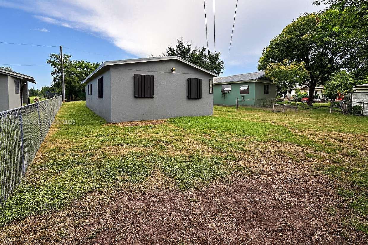 Chain-link fence, hurricane shutters, several windows for natural light