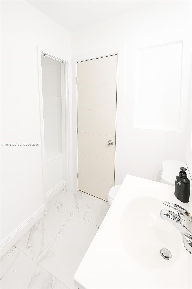 Towel hub behind bathroom door for added space