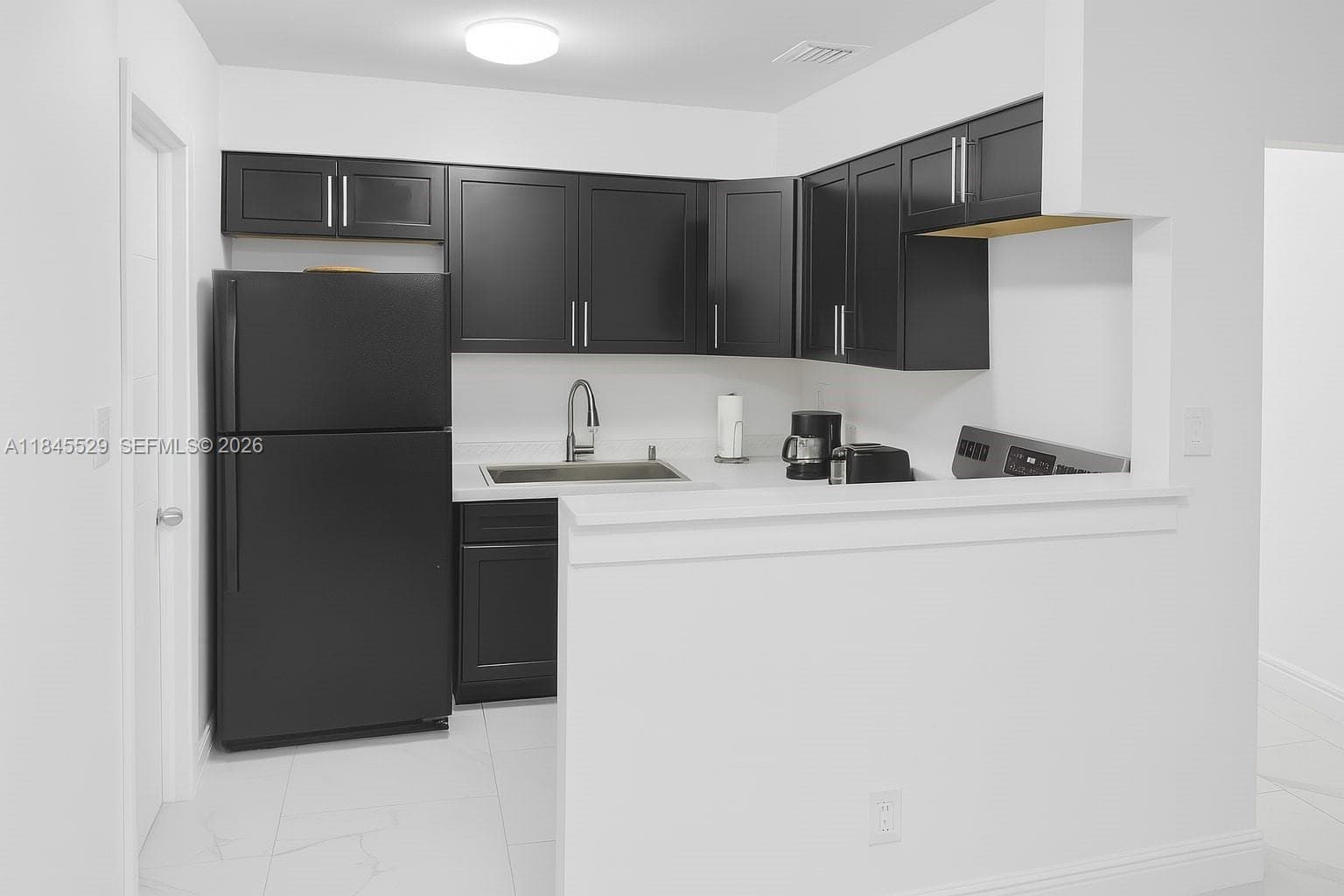 Newer shaker cabinets & open concept kitchen with coffee counter connects living/dining/kitchen space