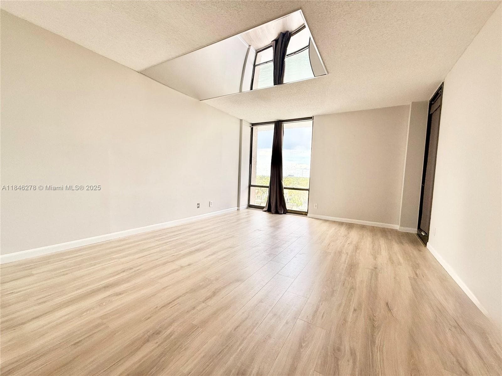 Primary bedroom with entrance to balcony