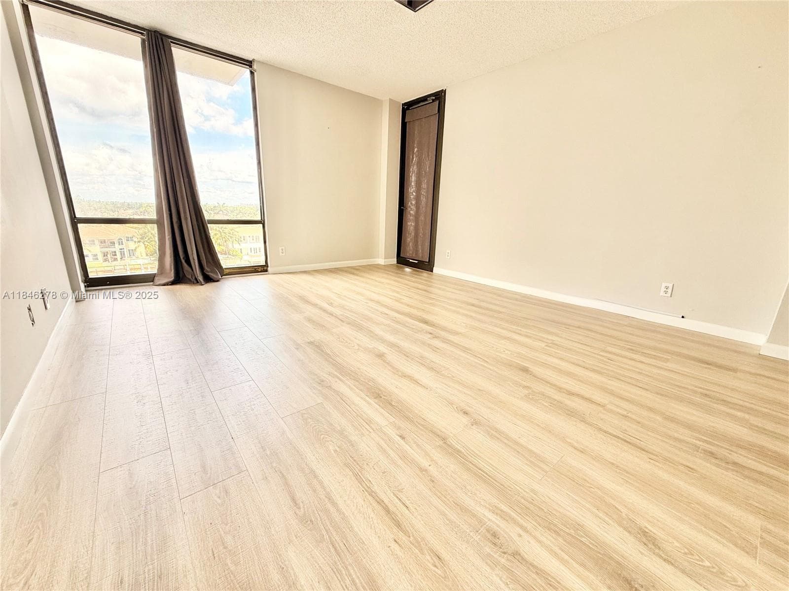Primary bedroom with entrance to balcony