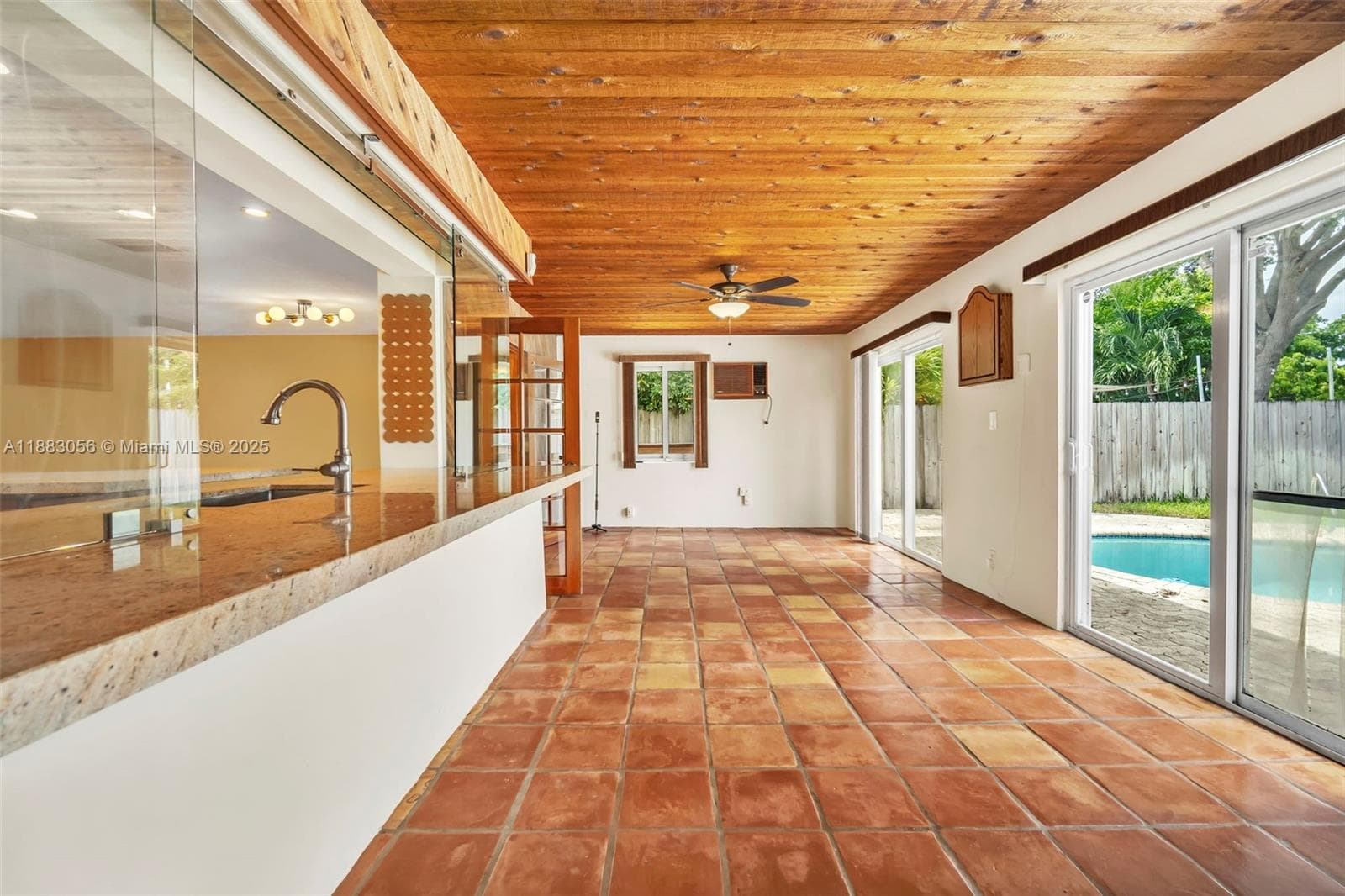 Pass thru from Kitchen.  Sliding doors to Pool.
