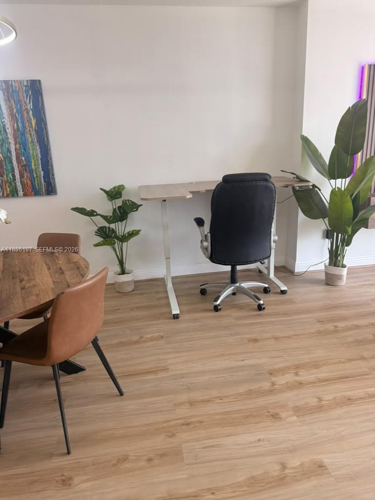 Light-toned wood-finish flooring throughout