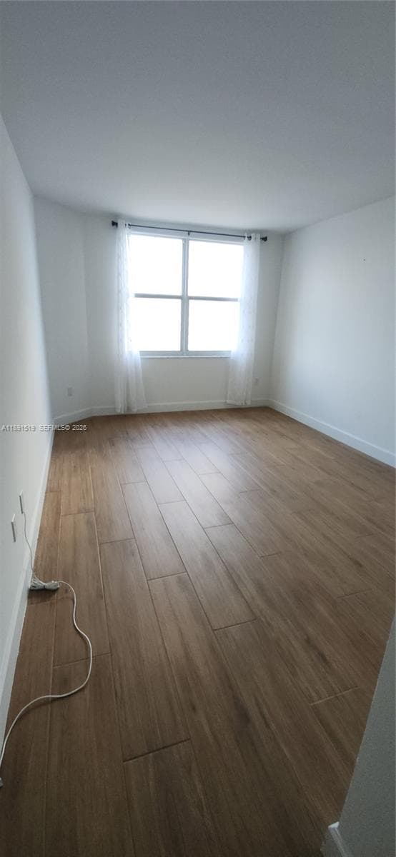 Porcelain floors, NO Popcorn ceilings in a spacious lengthy living dining areas