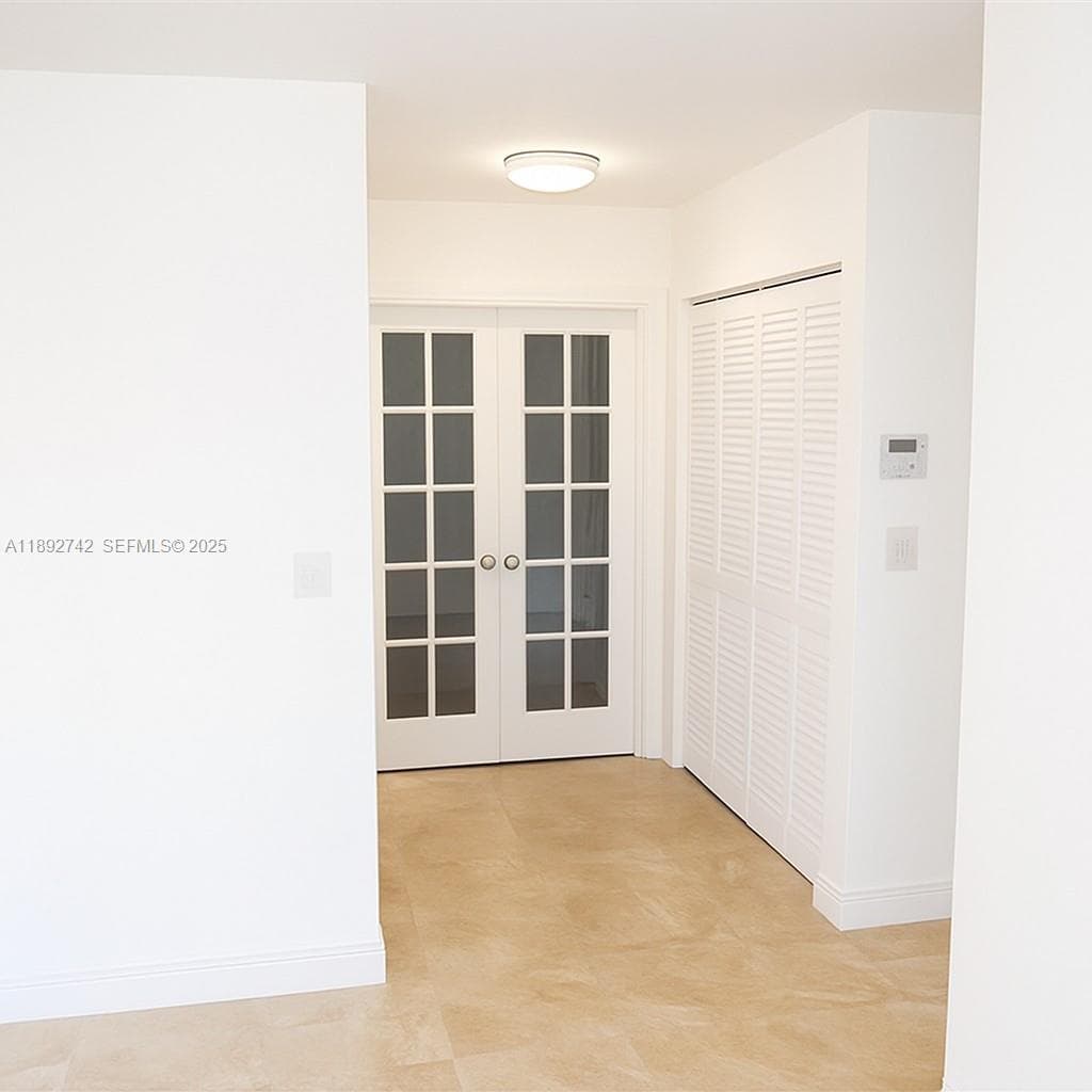 This is the hallway leading to the bedroom through French doors