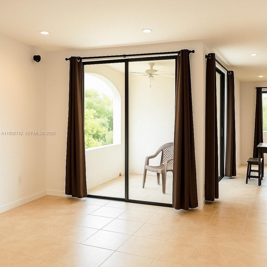 Natural light flows in from floor to ceiling sliding doors to the terrace.
