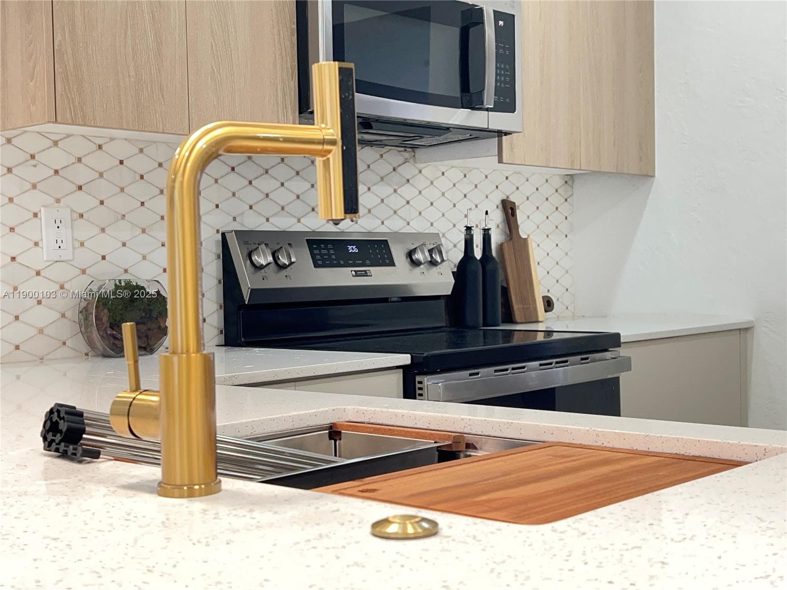 Undermount kitchen sink with a sapele wood cutting board, a stainless steel colander, a roll drying rack & a bottom rinse grid.