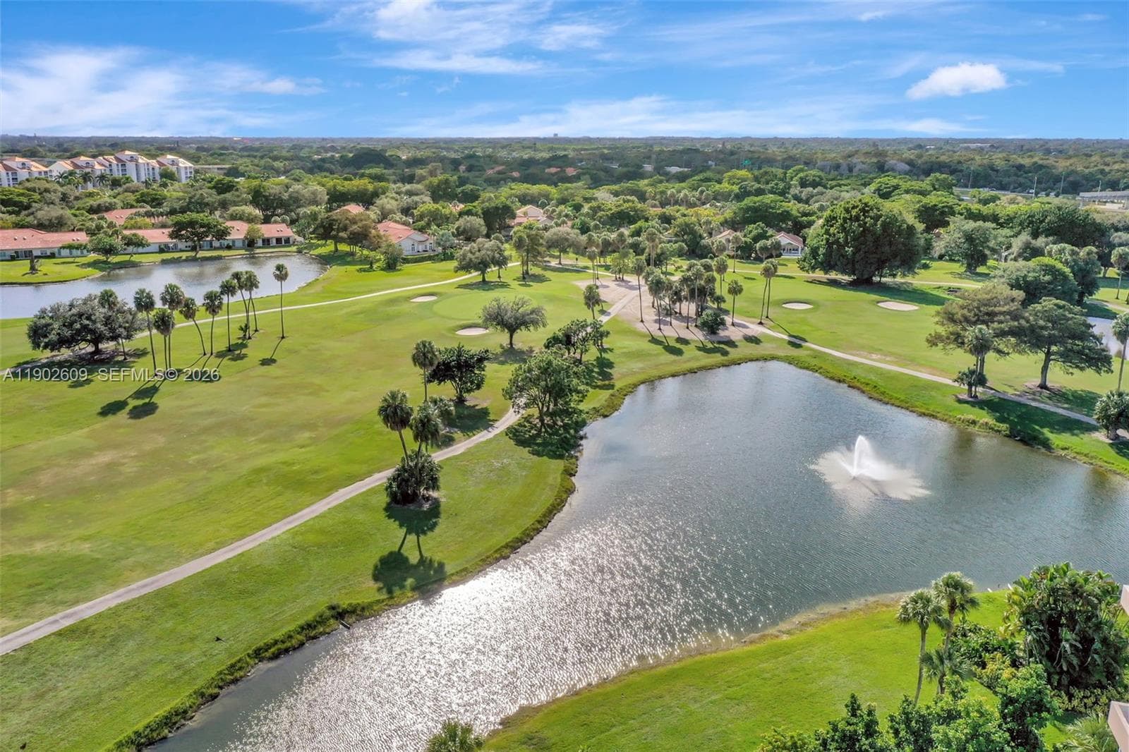 Welcome to this well-kept, resort-style community. The building is surrounded by mature trees, lush landscaping, and a circular drive with covered entry for easy drop-off — a great first impression every time you come home.