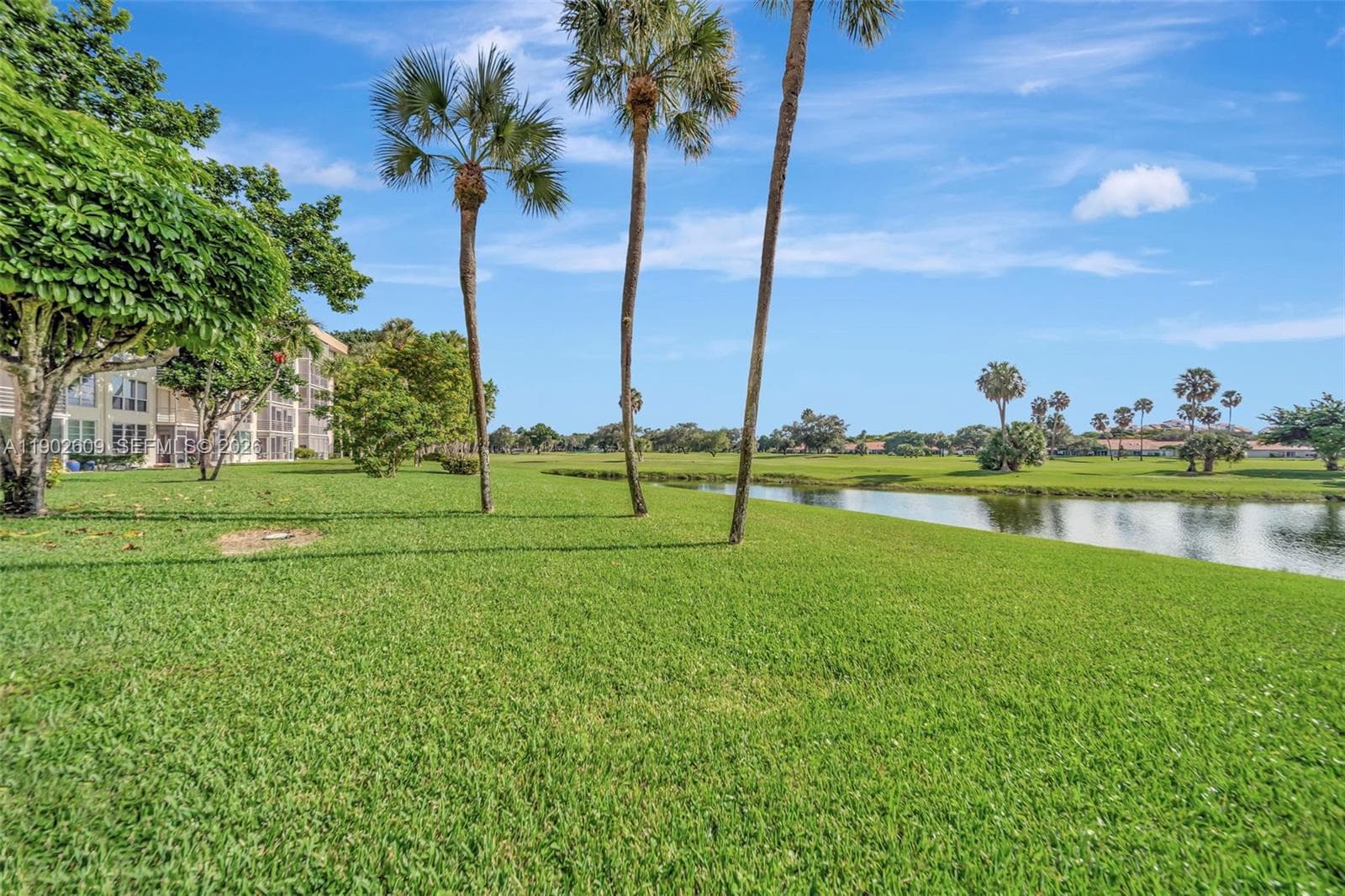 Covered, convenient, and welcoming — the porte cochère entry offers shaded drop-off and easy access to the lobby, surrounded by mature landscaping and a well-kept building exterior.