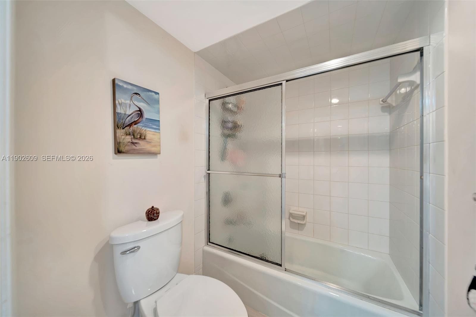 Spacious great room with multiple seating zones and direct access to the enclosed patio—perfect for relaxing while overlooking the greens and water.