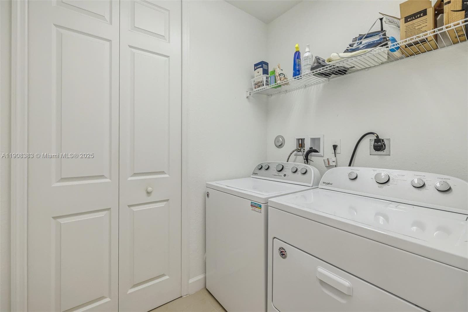 Ample laundry room with additional closet storage.