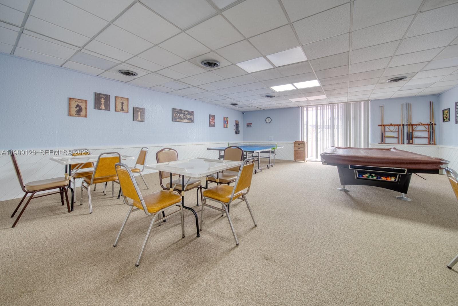 Fun community game room featuring tables and social spaces for residents.