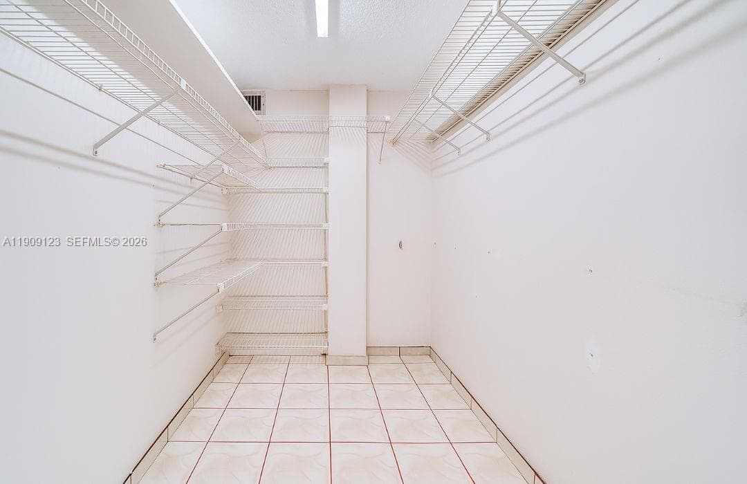 Spacious secondary bathroom featuring a shower/tub combo and ample storage.