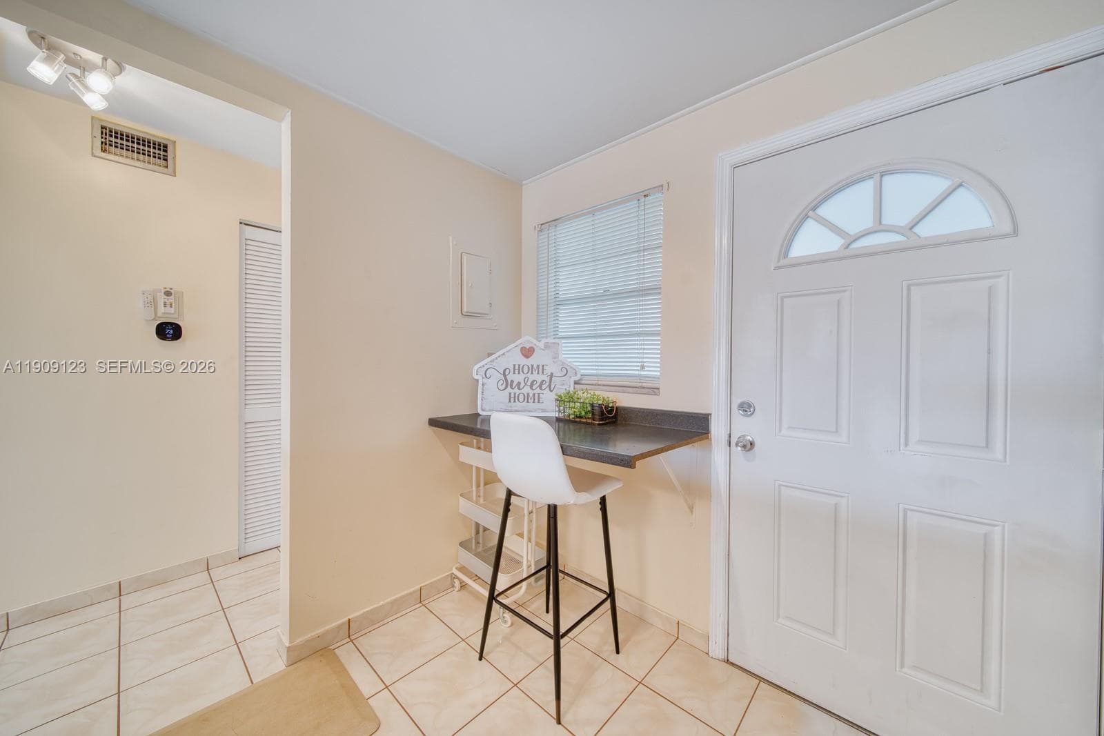 Another angle of the dining area showing flow to the kitchen and balcony.