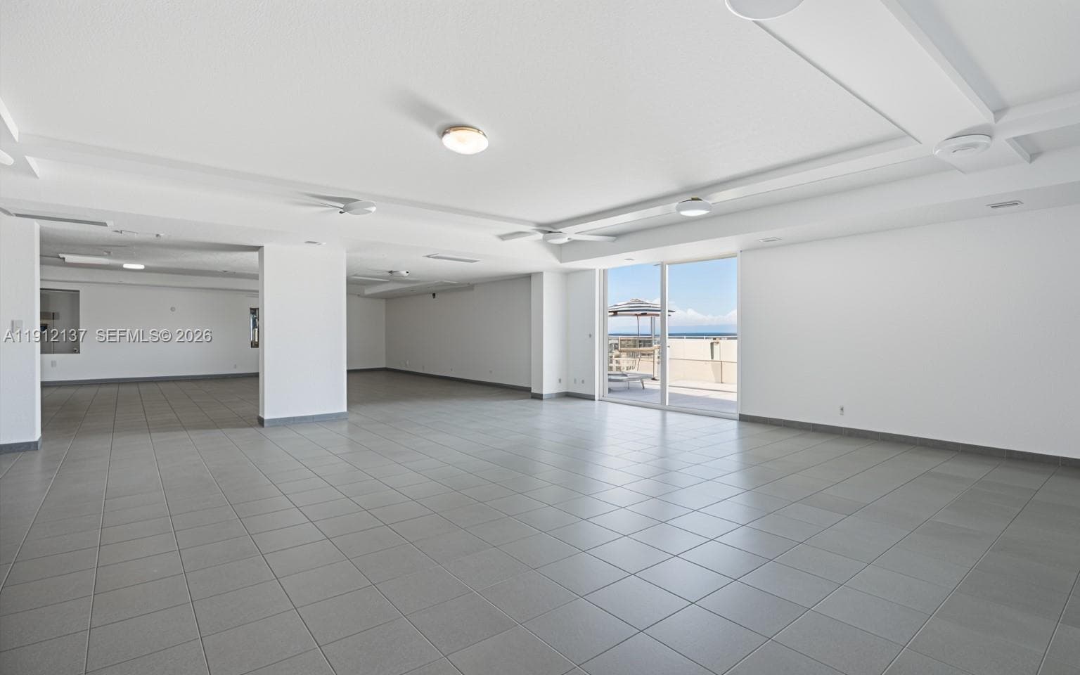 This bright and versatile recreation room offers the perfect space for gatherings, wellness activities, or social events — all set against a backdrop of stunning ocean views. The large sliding glass doors fill the room with natural light and open directly to the pool deck, creating a seamless indoor-outdoor flow. Whether used for private celebrations, meetings, or quiet relaxation, this inviting amenity enhances the building’s resort-style atmosphere and embodies the best of Miami Beach coastal living.