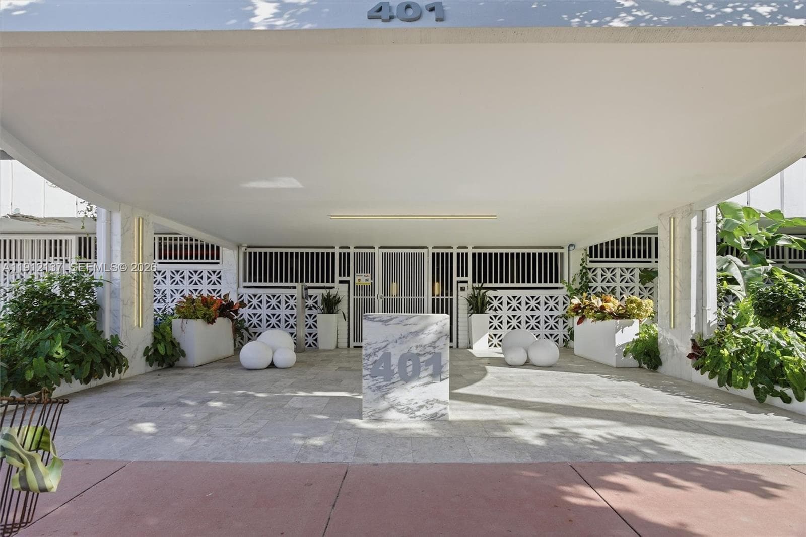 Welcome to 401 Ocean Drive — where timeless design meets modern security. The building’s main entrance offers a stylish and welcoming first impression, framed by lush tropical landscaping and sleek architectural details. Residents enjoy peace of mind with gated access, controlled entry, and a well-maintained lobby area that reflects the property’s elegant coastal aesthetic. Thoughtfully designed for both beauty and safety, this secured entryway perfectly complements the sophistication of South of Fifth livi