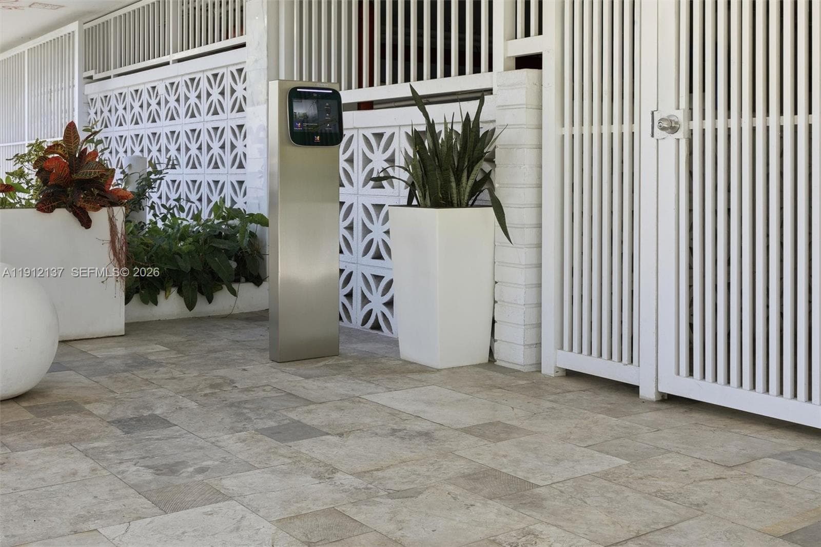 Welcome to 401 Ocean Drive — where timeless design meets modern security. The building’s main entrance offers a stylish and welcoming first impression, framed by lush tropical landscaping and sleek architectural details. Residents enjoy peace of mind with gated access, controlled entry, and a well-maintained lobby area that reflects the property’s elegant coastal aesthetic. Thoughtfully designed for both beauty and safety, this secured entryway perfectly complements the sophistication of South of Fifth livi
