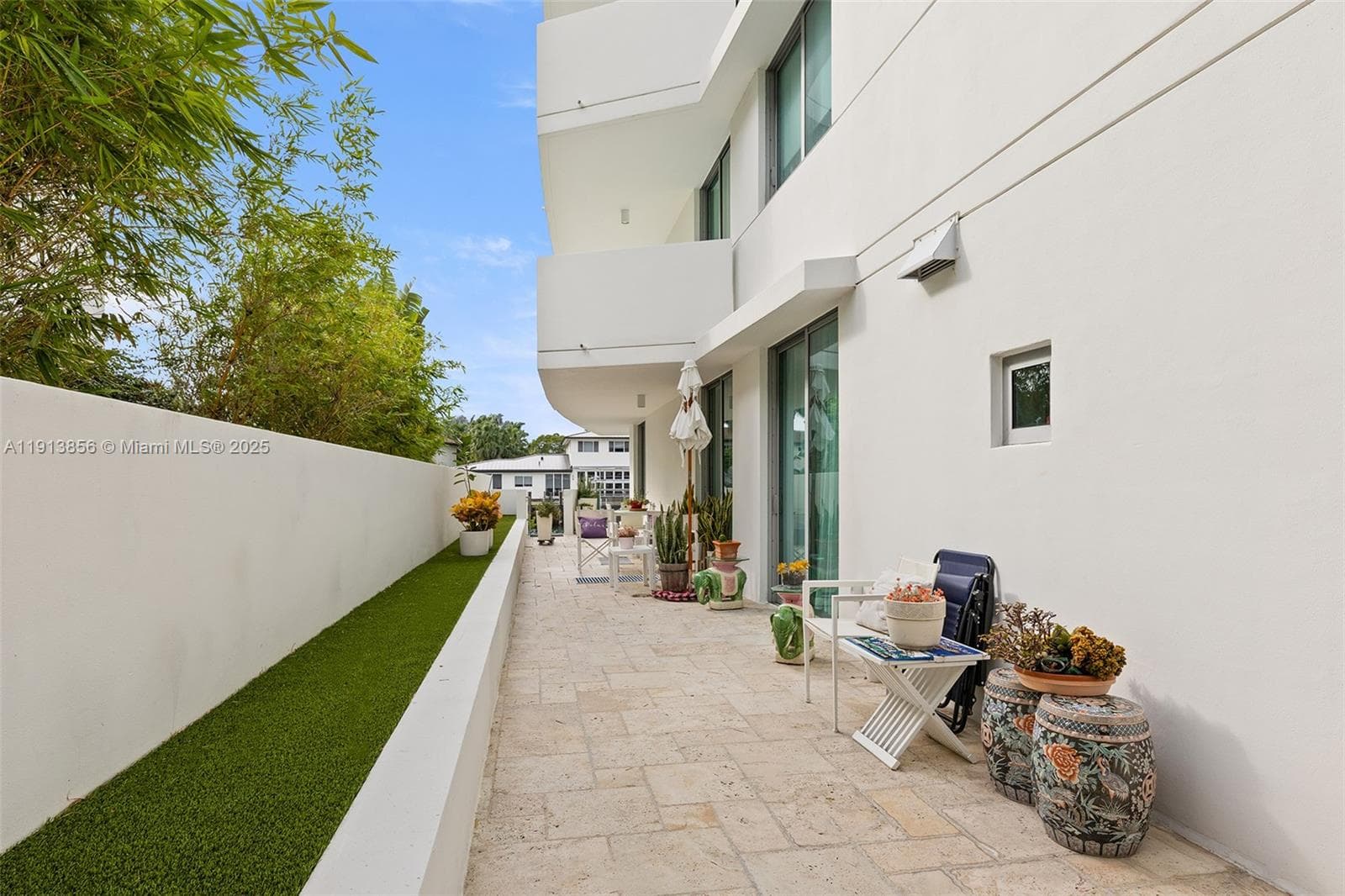 Private side yard running from primary suite all along the residence toward the water
