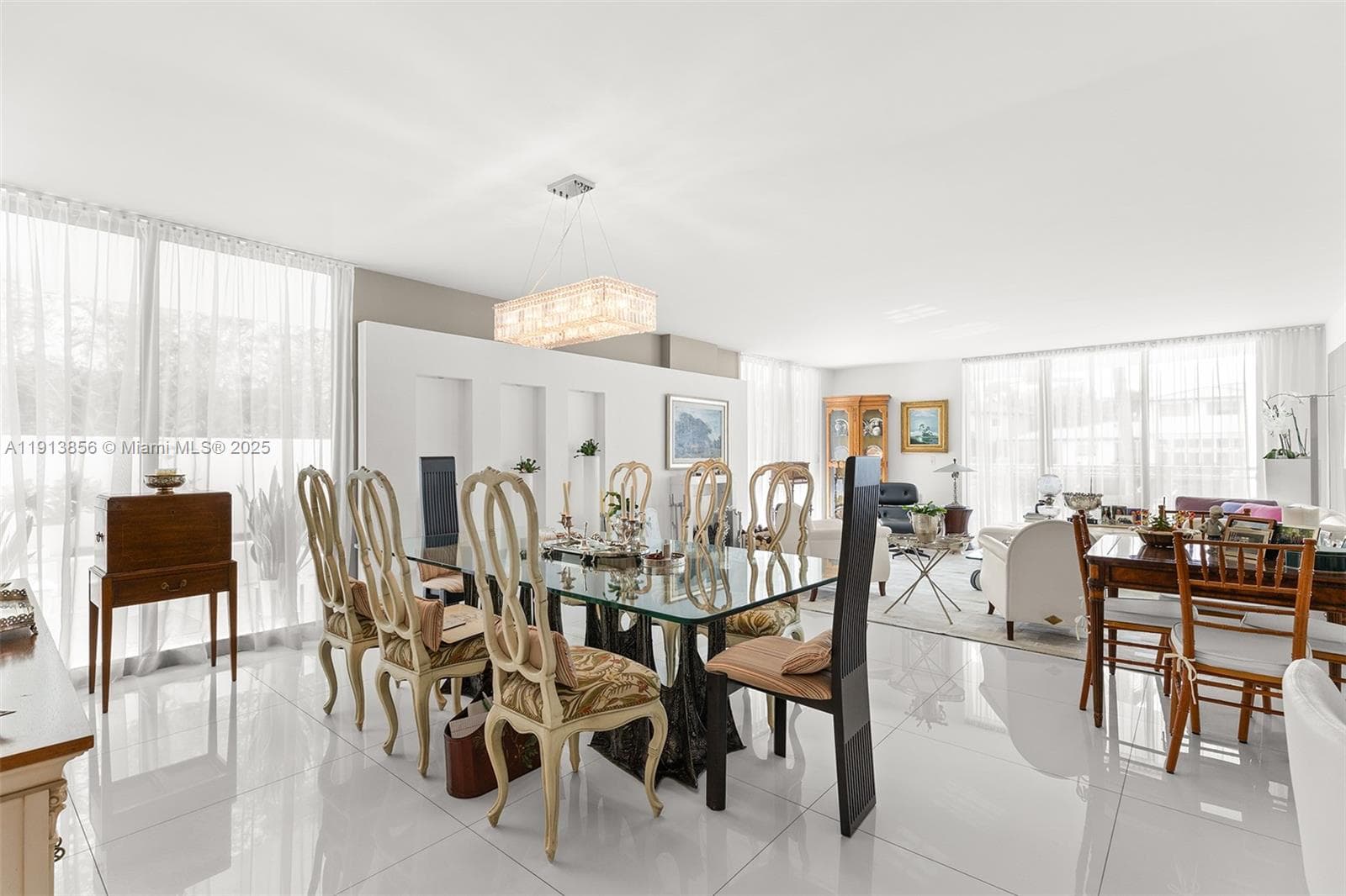 Wide angle view of dining area and great room with sliding doors toward the waterfront