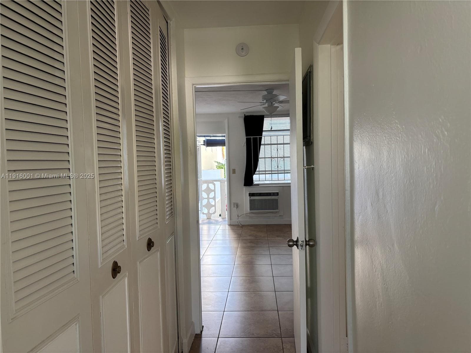Hallway with big closet on the left and bathroom on the right