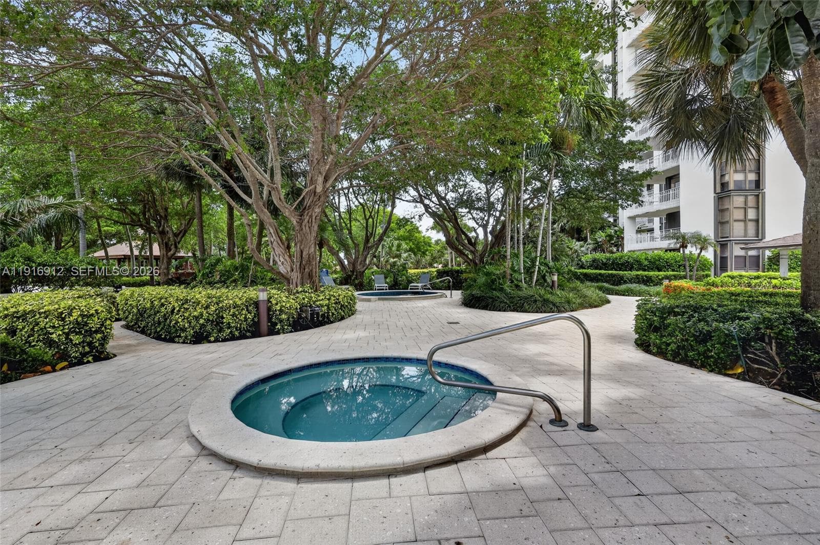 With its beautifully landscaped surroundings and calming ambiance, this inviting spa area feels like a hidden oasis right at home