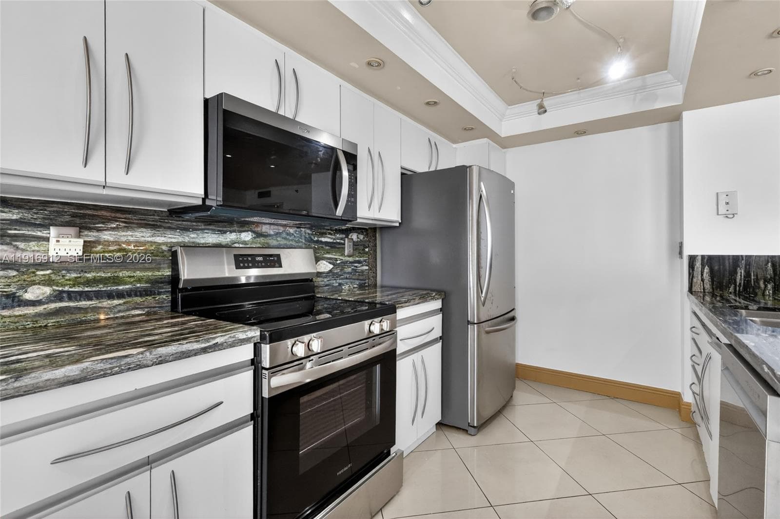 A gorgeous kitchen with emerald-green granite countertops and brand-new appliances, combining natural elegance with modern convenience