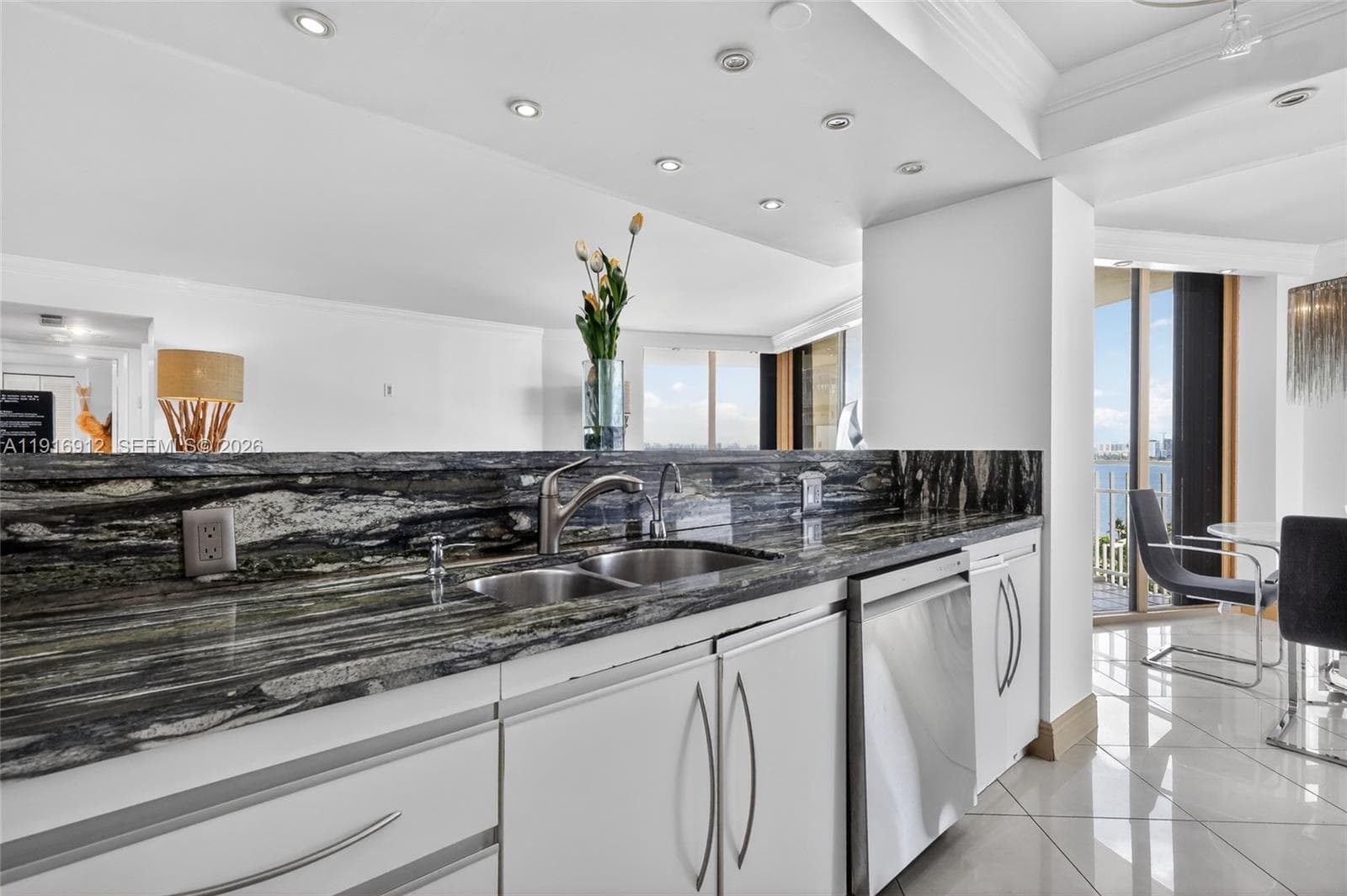 Beautiful, light-filled kitchen features striking emerald-green granite countertops that bring a rich, natural elegance to the space