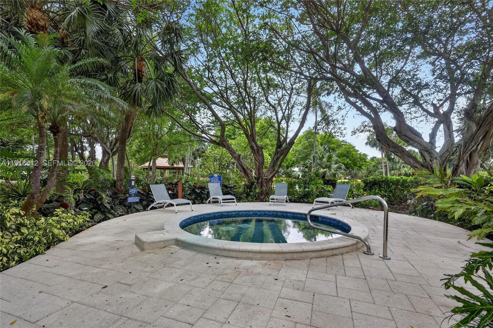 With its beautifully landscaped surroundings and calming ambiance, this inviting spa area feels like a hidden oasis right at home