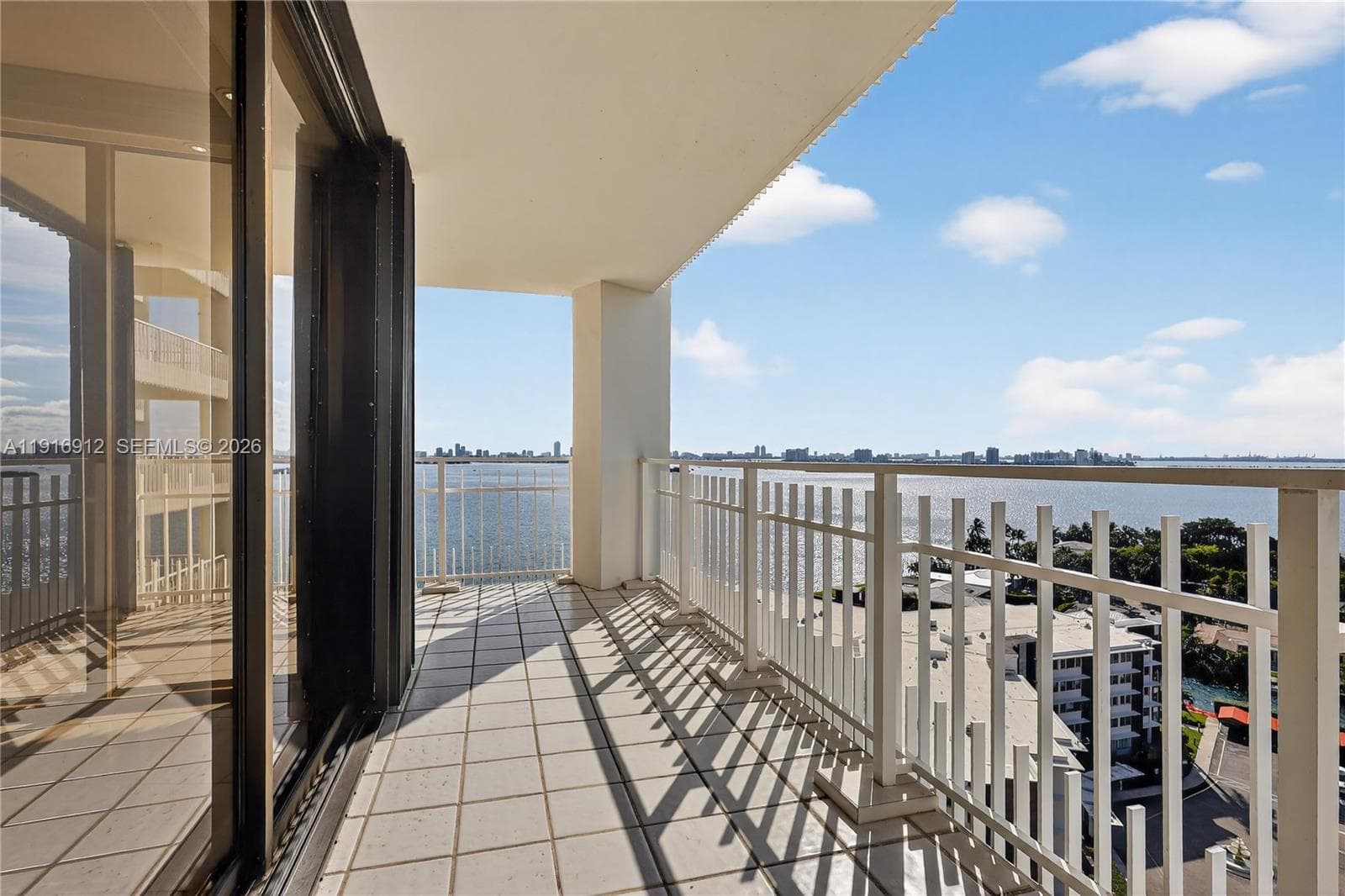 This unit boasts a private balcony showcasing captivating water views and a dynamic skyline that glows at night
