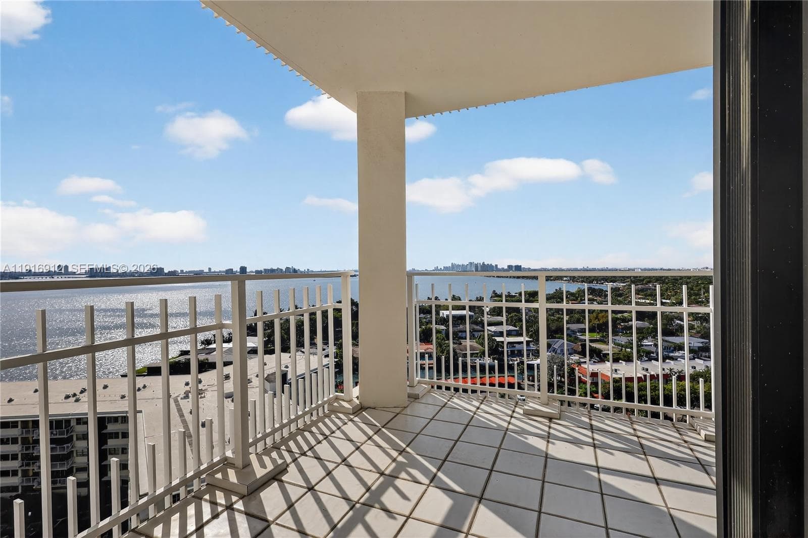The balcony offers a panoramic outlook where sparkling waters meet an impressive city skyline—an unforgettable backdrop any time of day