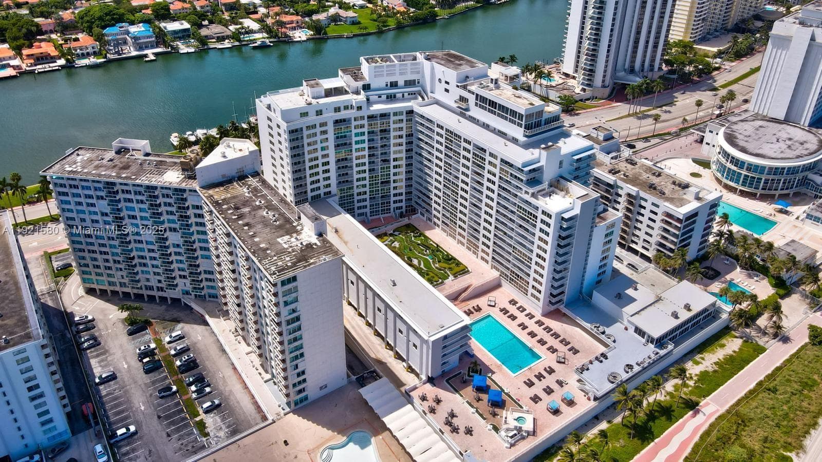 Unit located on top floor of the low-rise building to the left of the pool
