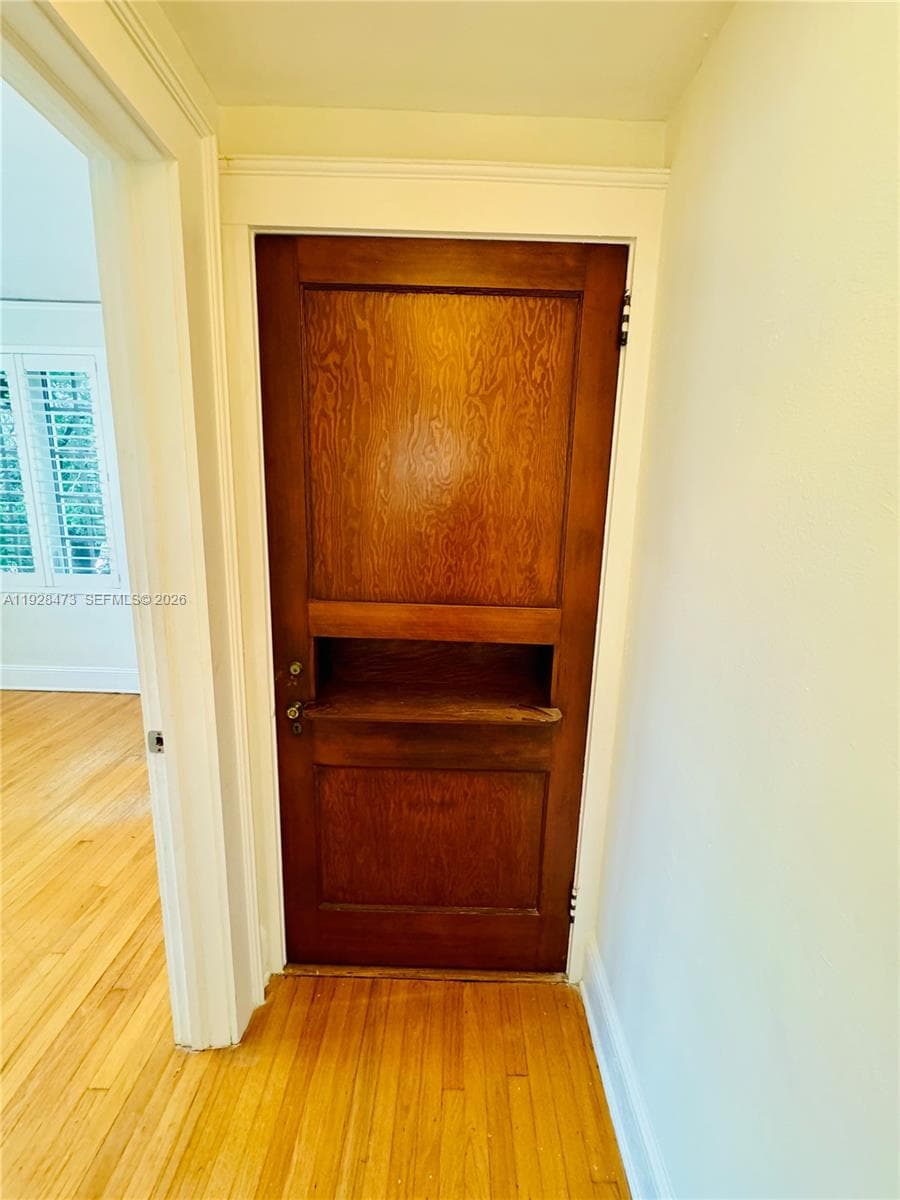 Hallway closet with original ornate door