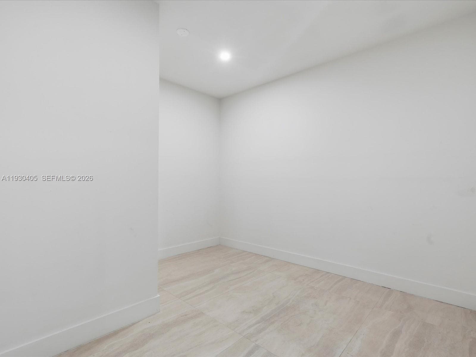 Neutral-toned interior space featuring light wood-finish flooring and recessed lighting