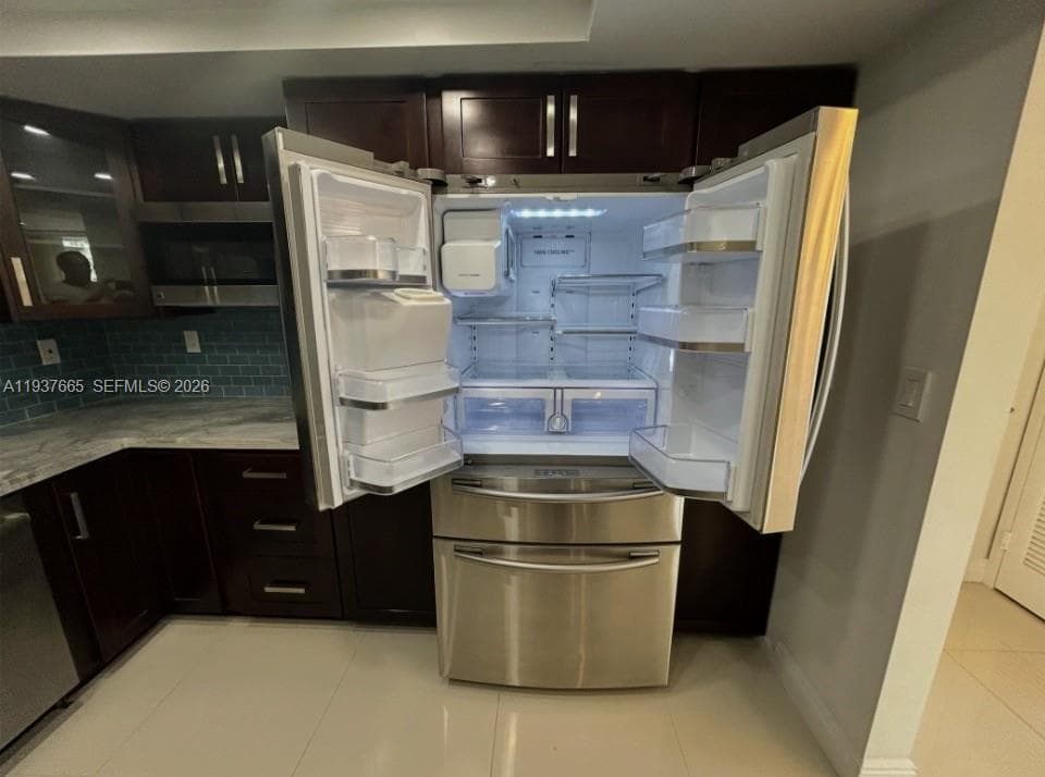 solid stone kitchen counter, under counter sink and custom backsplash