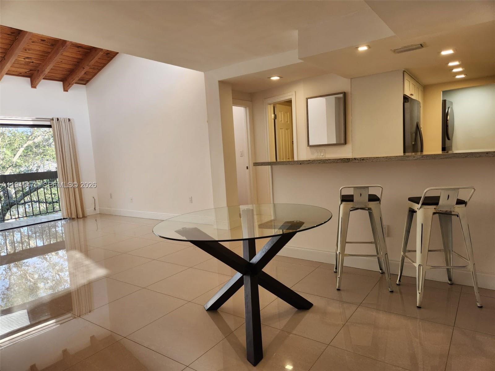 View as you enter the unit shows dining living area with open kitchen.