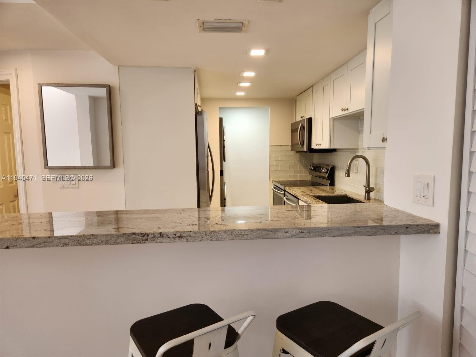 Additional view from bar area into kitchen.