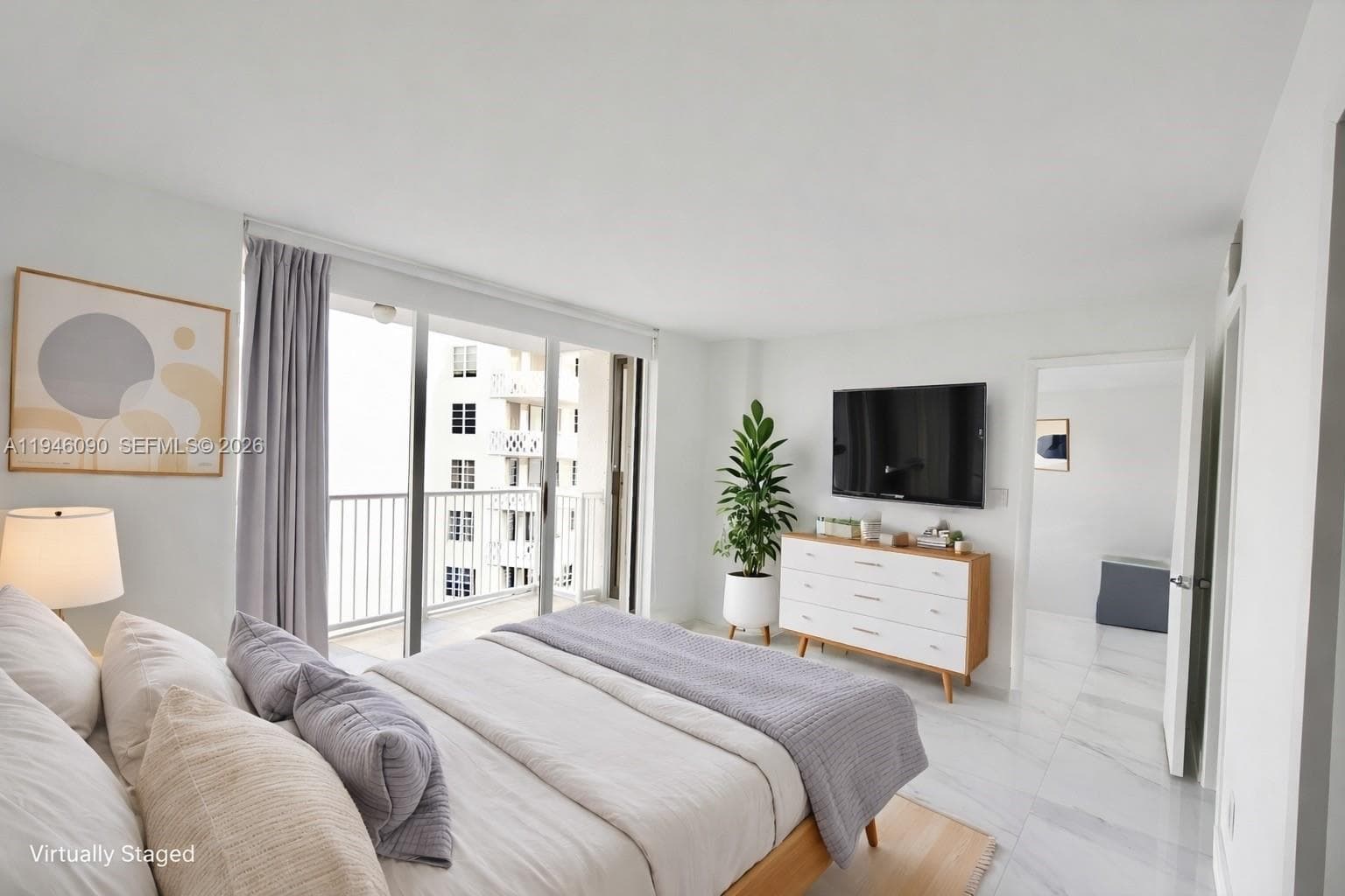 Spacious bedroom with en-suite bathroom, walk-in closet, and blackout shades