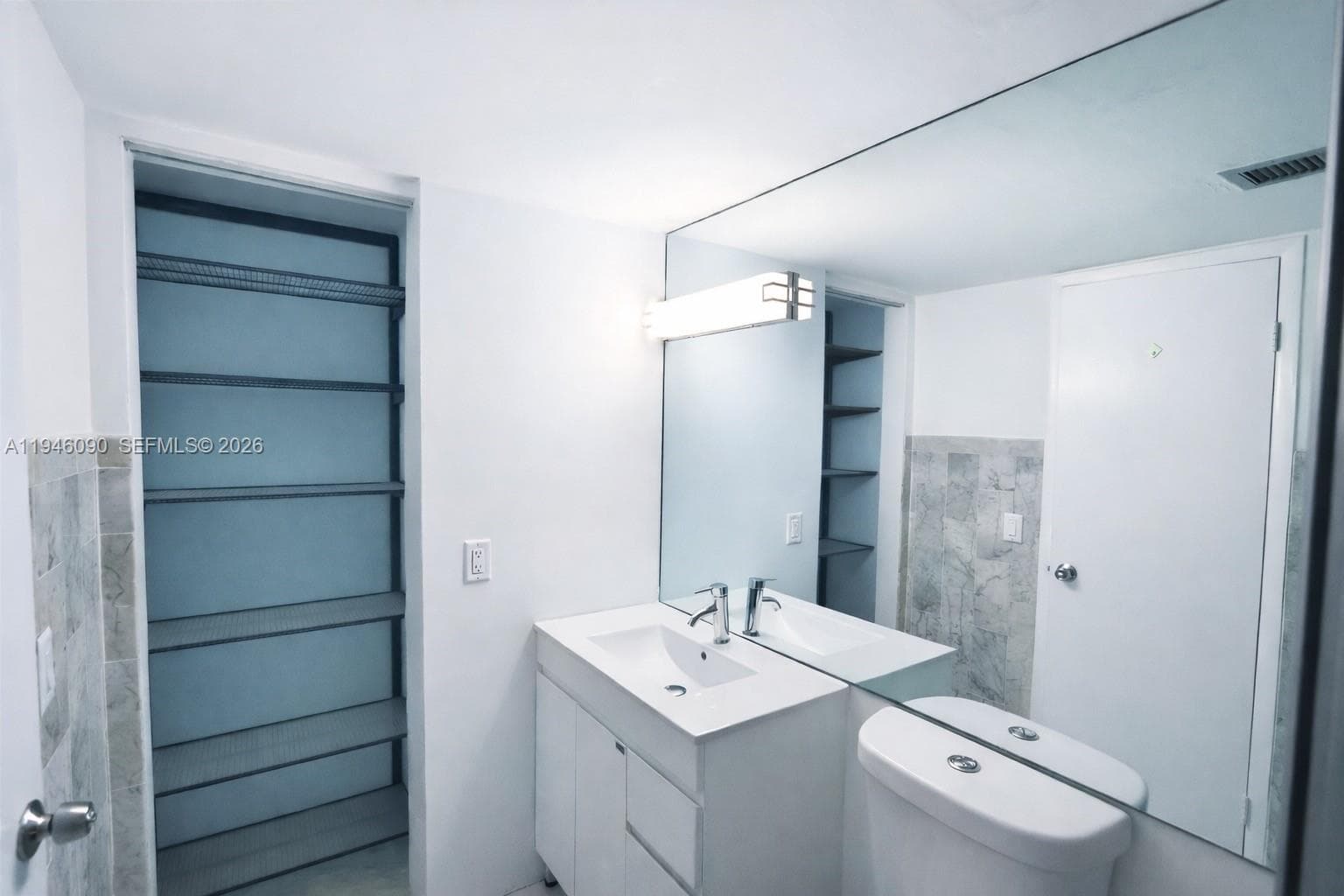 Totally remodeled bathroom with ample storage for linens and towels