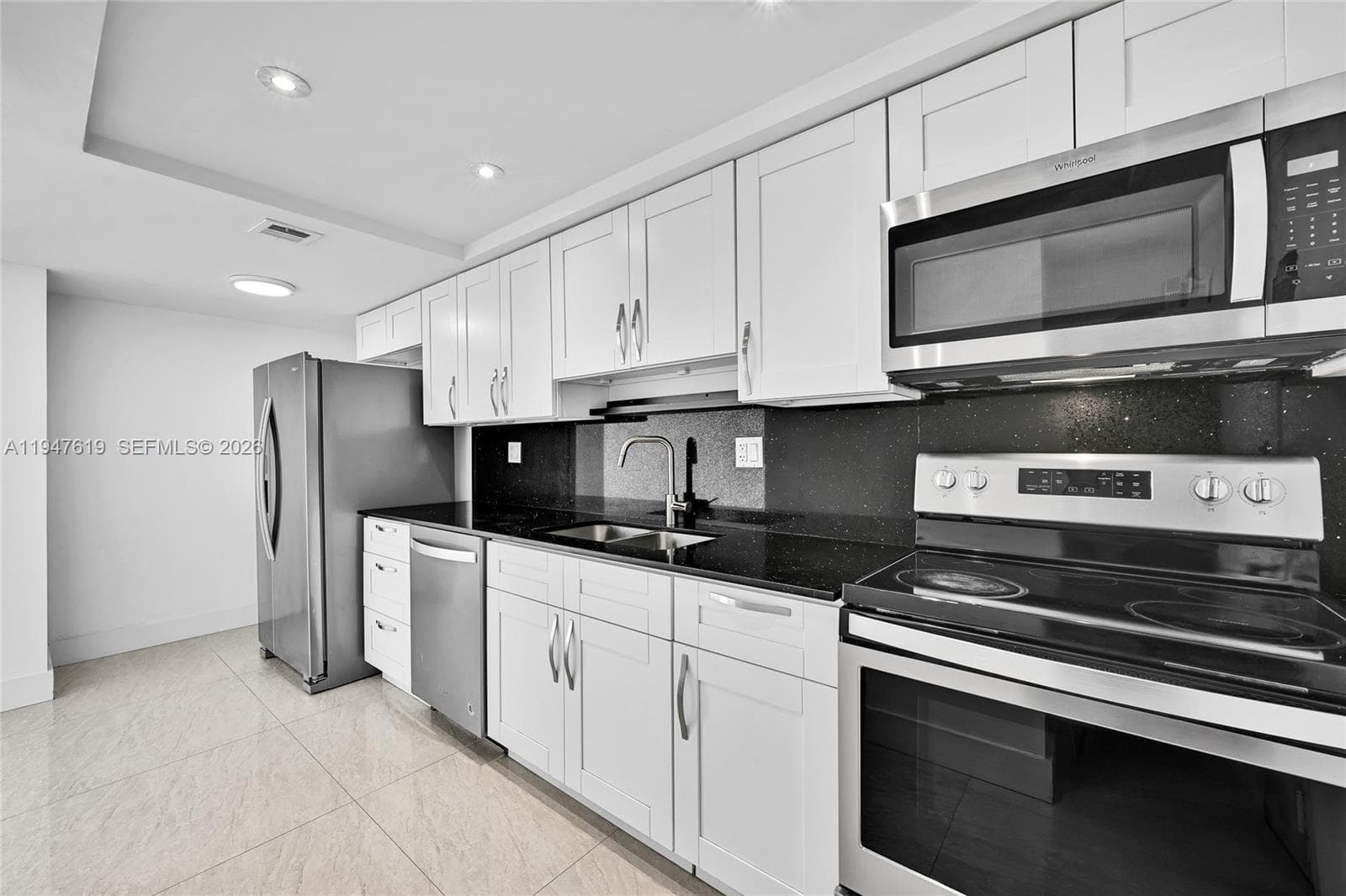 Modern kitchen with stainless steel appliances.