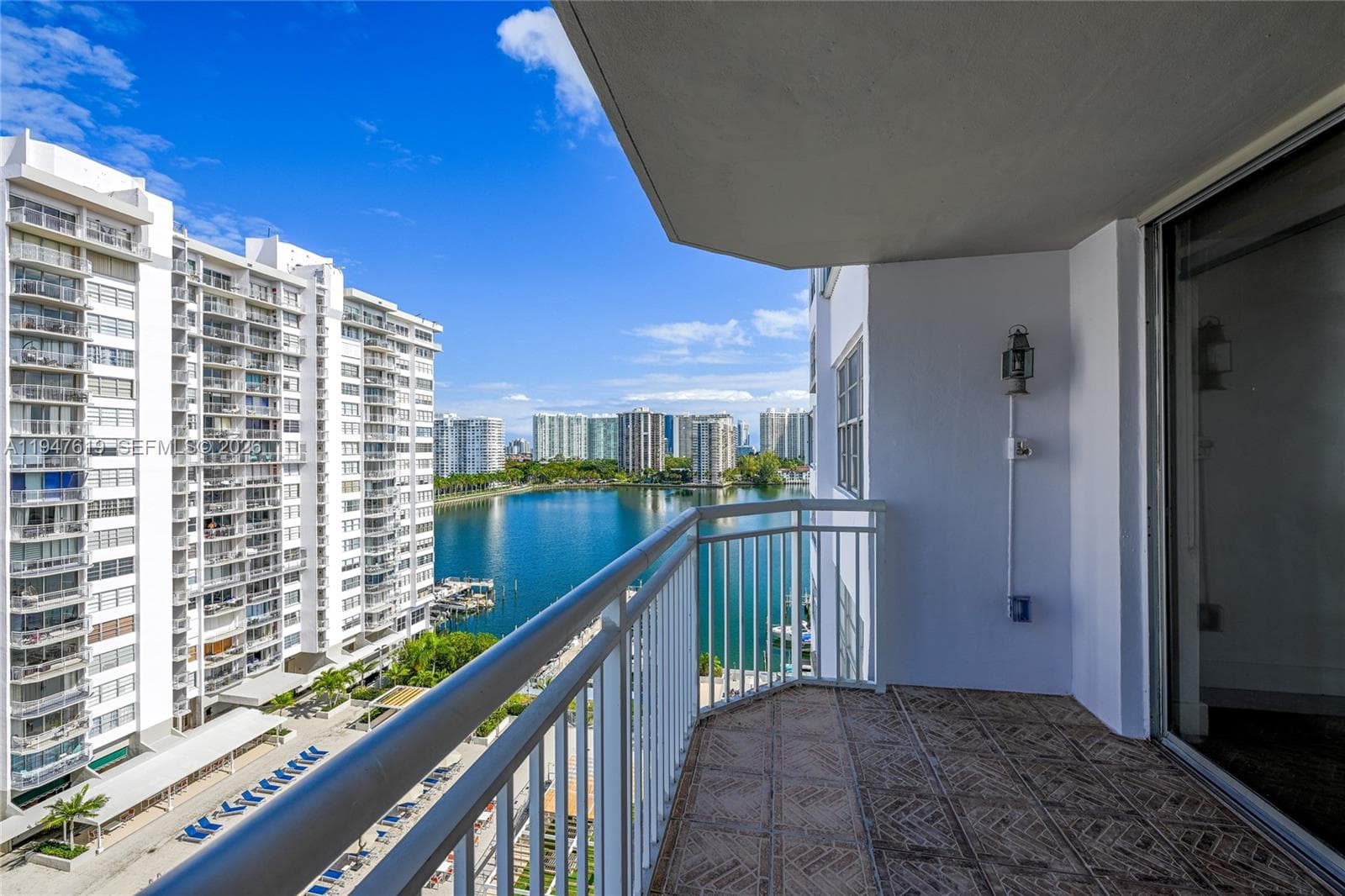 Serene balcony with pool, marina, and bay views