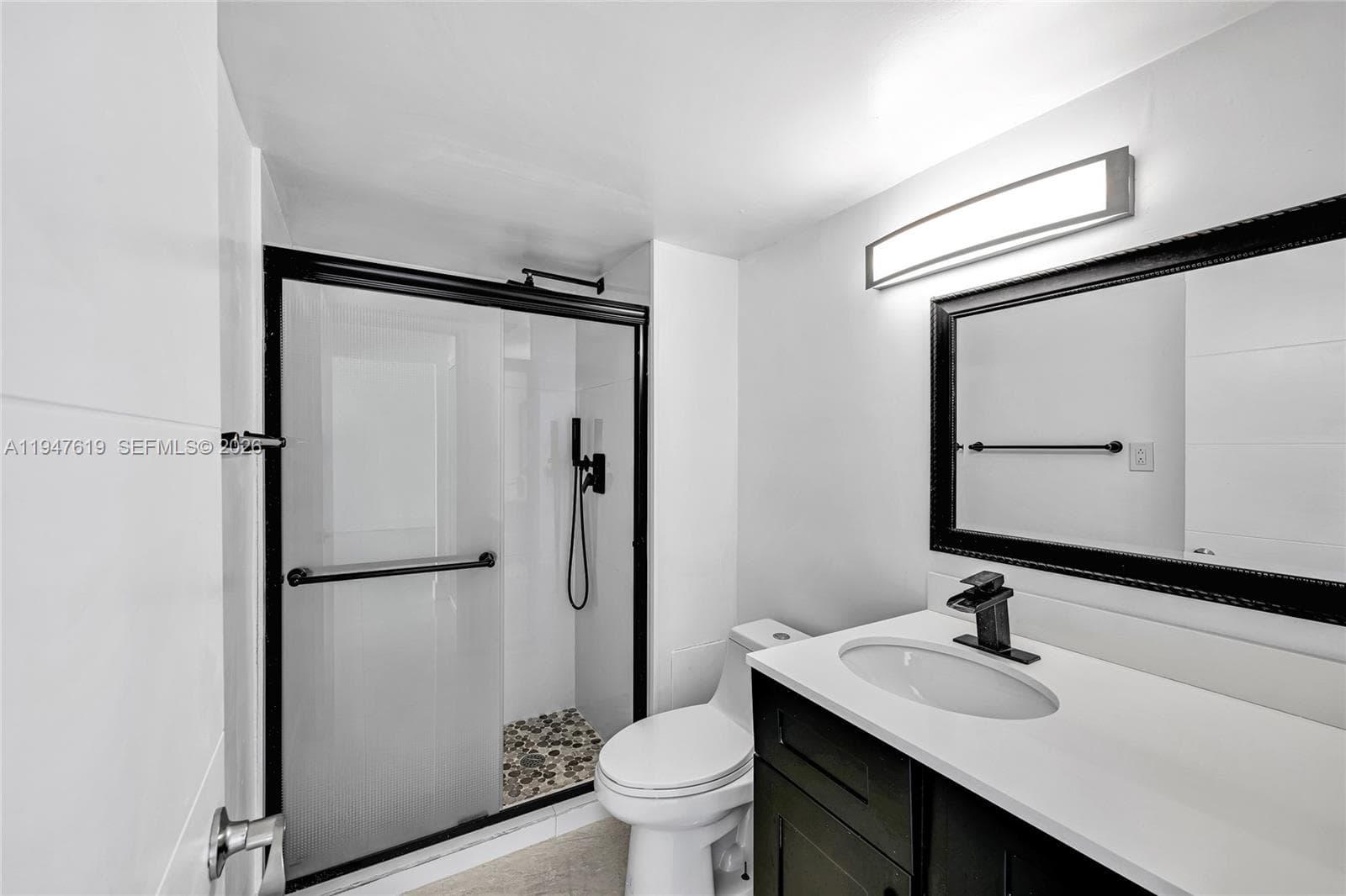 Updated guest bath with modern fixtures and porcelain tile