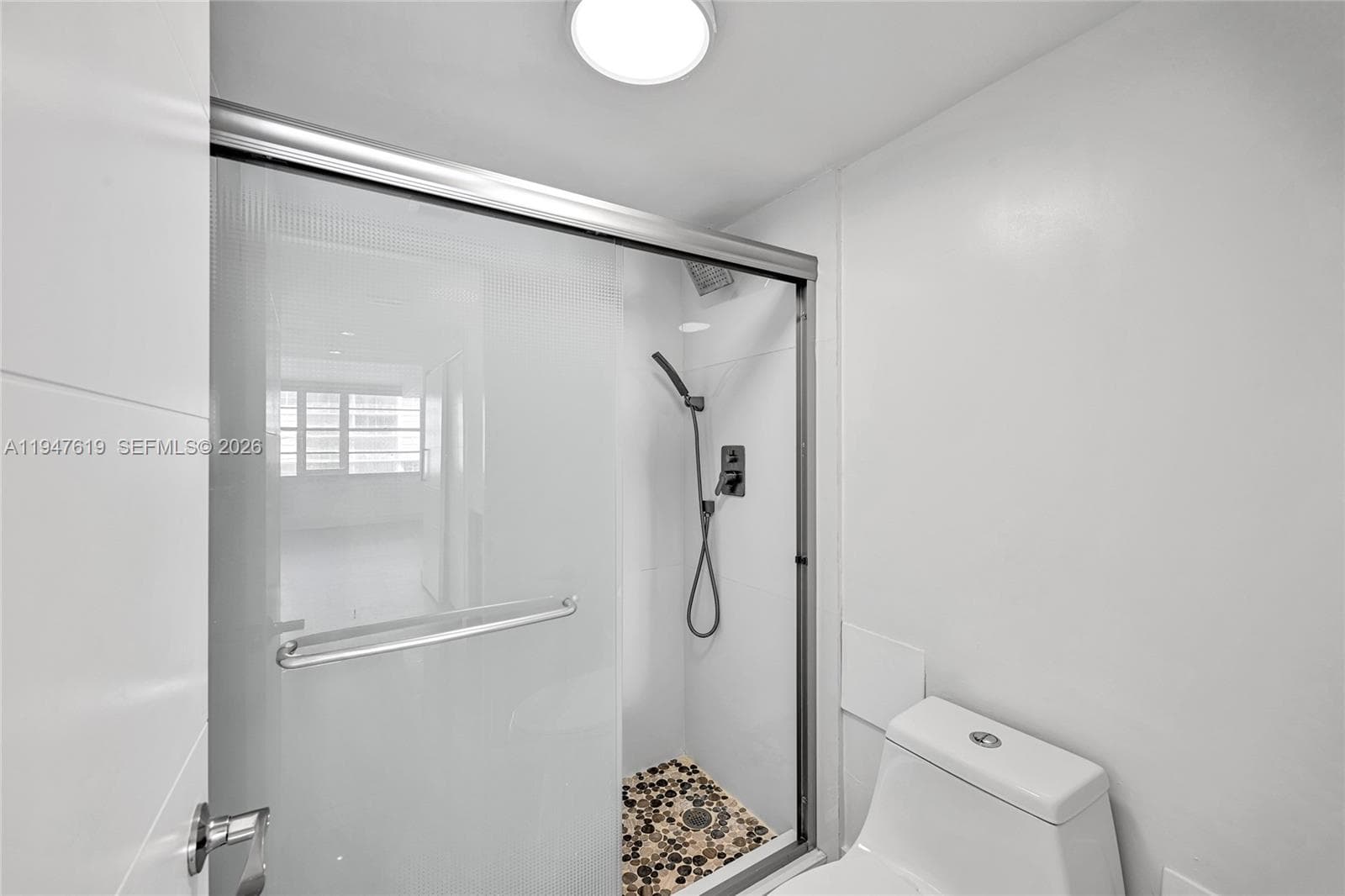 Spa-like bathroom with porcelain tile and frameless glass shower