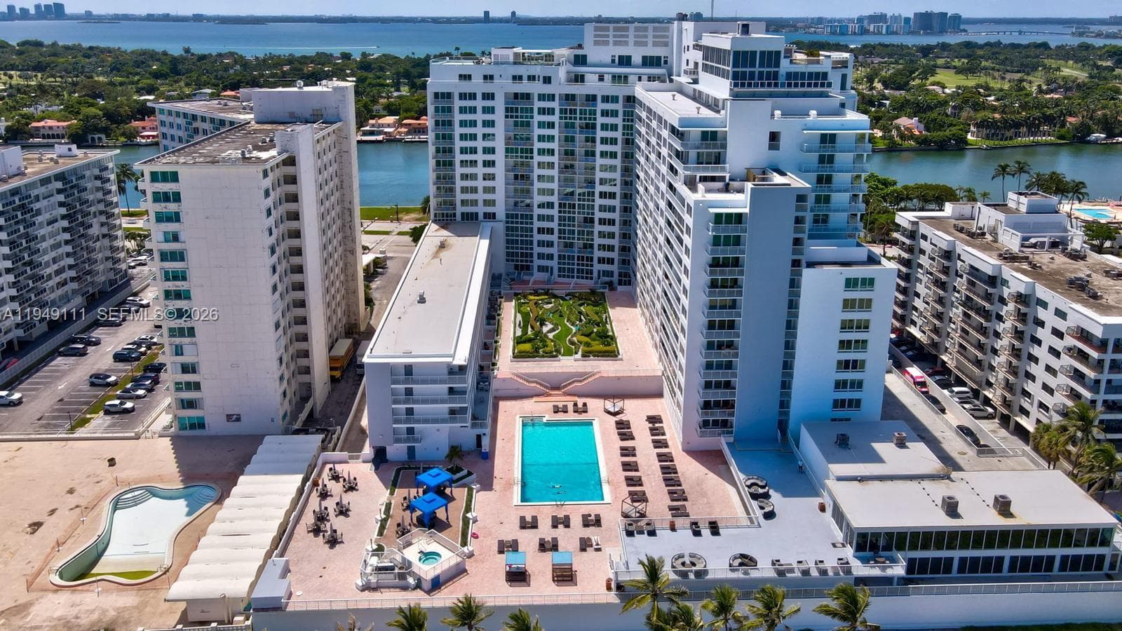 Unit located on top floor of the low-rise building to the left of the pool