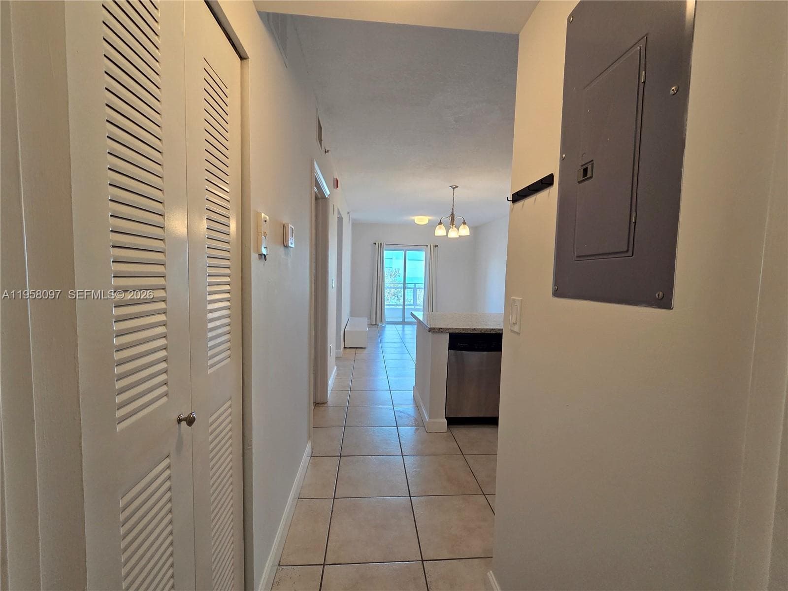 Entry perspective showcasing the open floor plan leading directly to the living room and balcony.