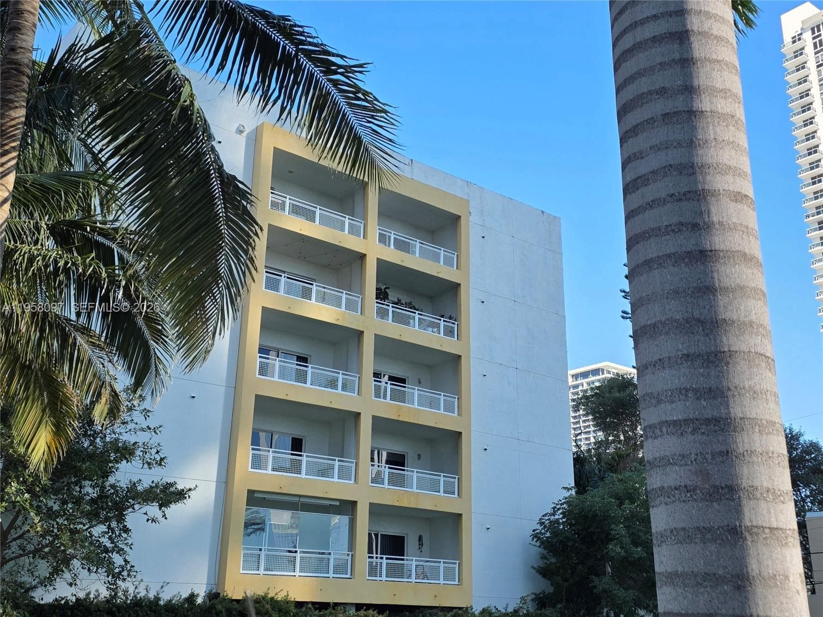 Corner perspective of building façade showcasing multiple private balconies.