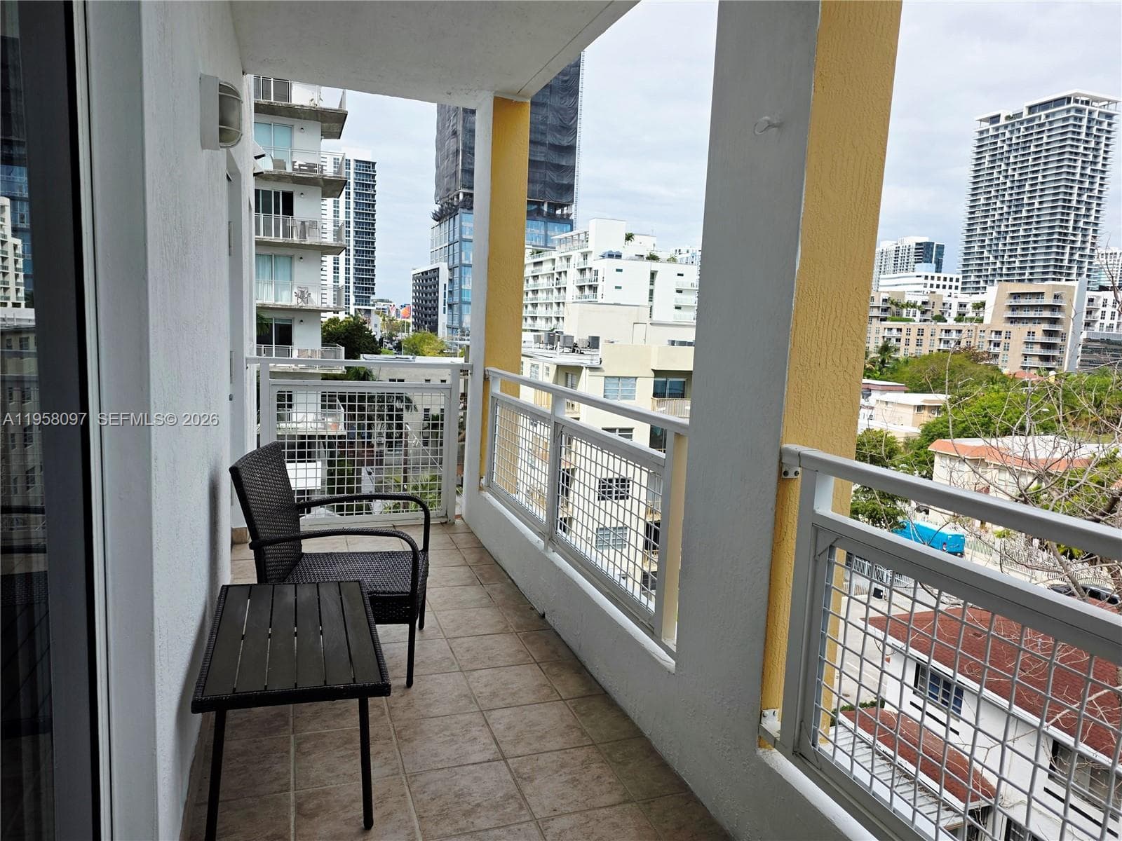 Spacious balcony offering city skyline views.